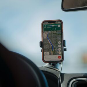 Smartphone navigation app displaying a route on car dashboard