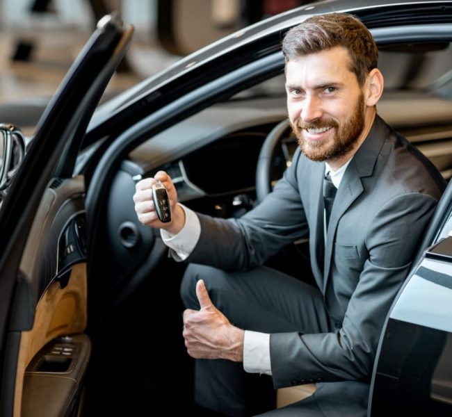 businessman-in-the-luxury-car-at-the-showroom.jpg